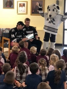 PC Hockey players reading to school children
