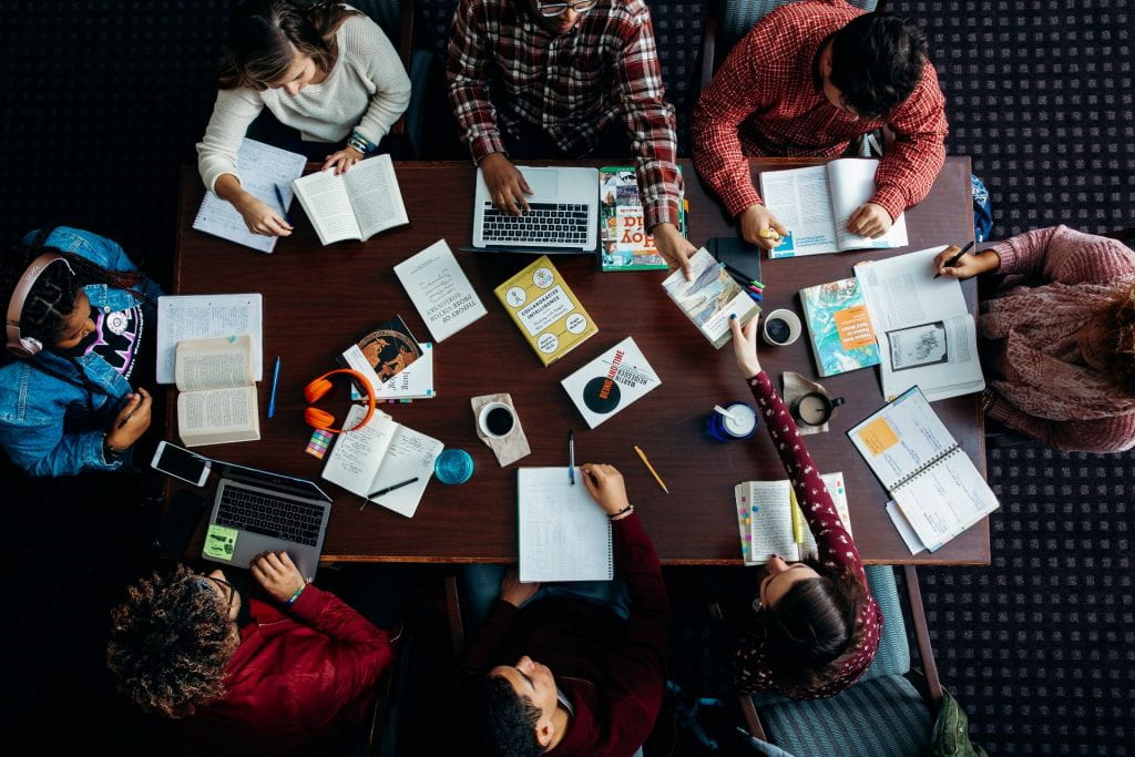 Overhead image of students seated around a table