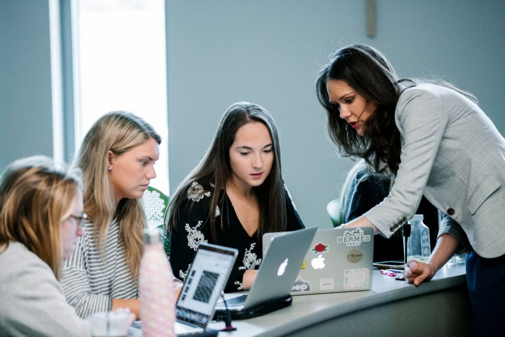 Professor helping students in class