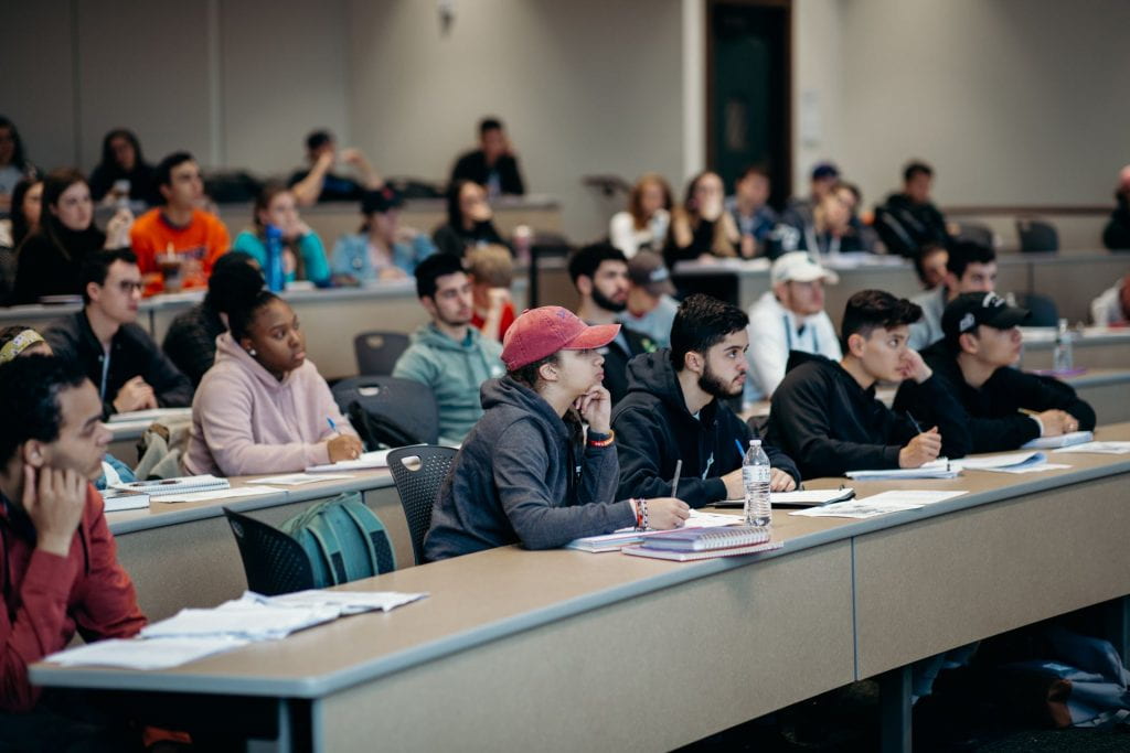 students sitting in rows engaged in a class lecture