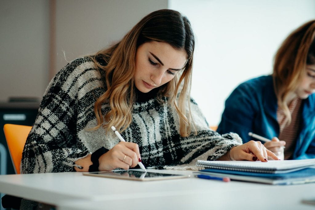 Student reading and taking notes